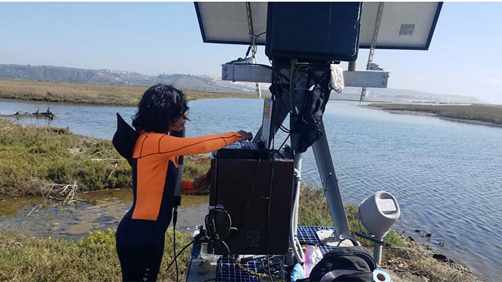 Graduate student Stephany Garcia performed maintenance at the sensor deployment site, Boca Rio, in the Tijuana River Estuary.