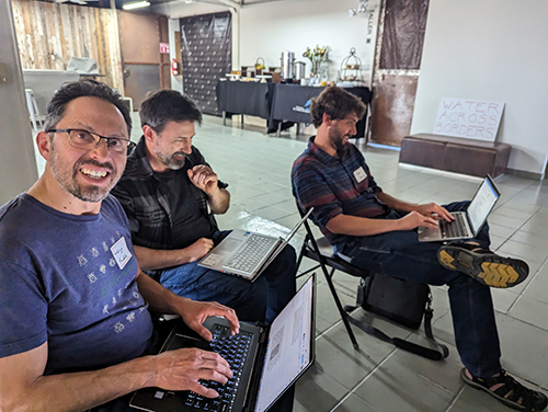 participants typing notes on laptops